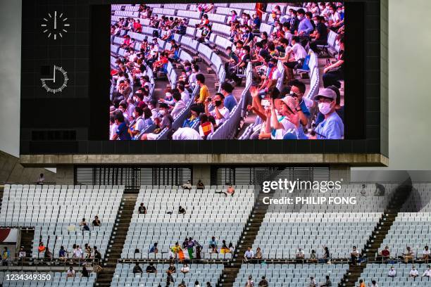 Big screen shows the audience before the Tokyo 2020 Olympic Games men's quarter-final match between Spain and Ivory Coast at Miyagi Stadium in Miyagi...