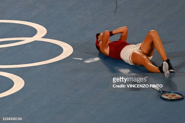 Switzerland's Belinda Bencic celebrates after defeating Czech Republic's Marketa Vondrousova during their Tokyo 2020 Olympic Games women's singles...