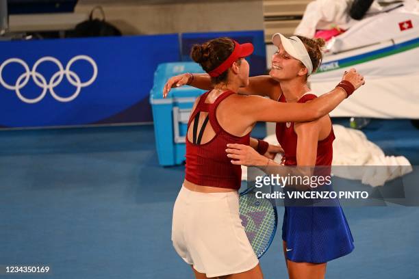 Switzerland's Belinda Bencic ambraces Czech Republic's Marketa Vondrousova after winning their Tokyo 2020 Olympic Games women's singles tennis final...