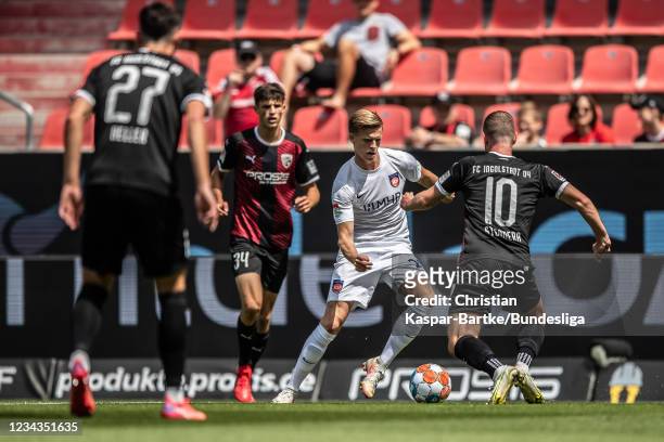Dzenic Burnic of 1.FC Heidenheim is tackled by Marc Stendera of 1.FC Ingolstadt during the Second Bundesliga match between FC Ingolstadt 04 and 1. FC...