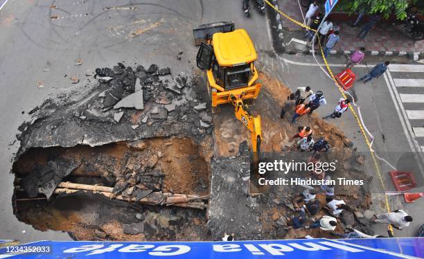 Section of a road caves in under IIT Delhi flyover, on July 31, 2021 in New Delhi, India. Due to the collapse of the road near IIT traffic signal,...