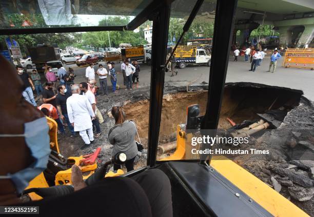 Section of a road caves in under IIT Delhi flyover, on July 31, 2021 in New Delhi, India. Due to the collapse of the road near IIT traffic signal,...