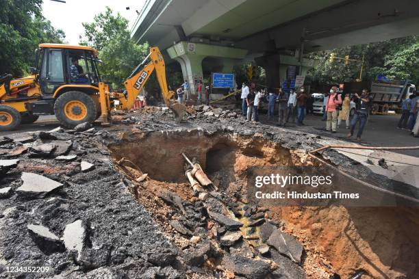 Section of a road caves in under IIT Delhi flyover, on July 31, 2021 in New Delhi, India. Due to the collapse of the road near IIT traffic signal,...