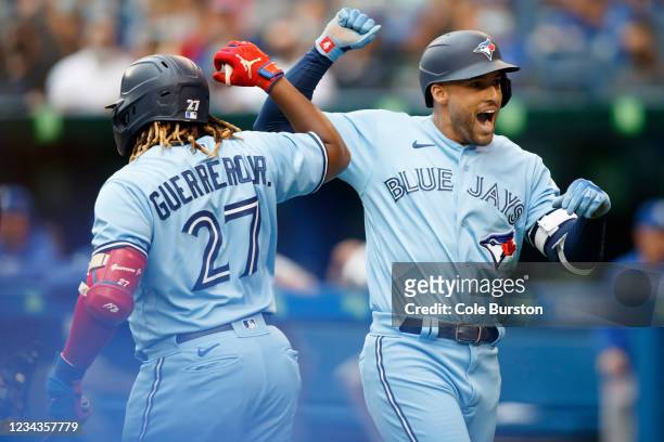 George Springer of the Toronto Blue Jays celebrates a home run with teammate Vladimir Guerrero Jr. #27 in the first inning during the MLB game...