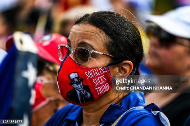 Woman wears a mask with the image of Donald Trump during a rally in calling for Freedom in Cuba, Venezuela and Nicaragua, in Miami, on July 31, 2021....