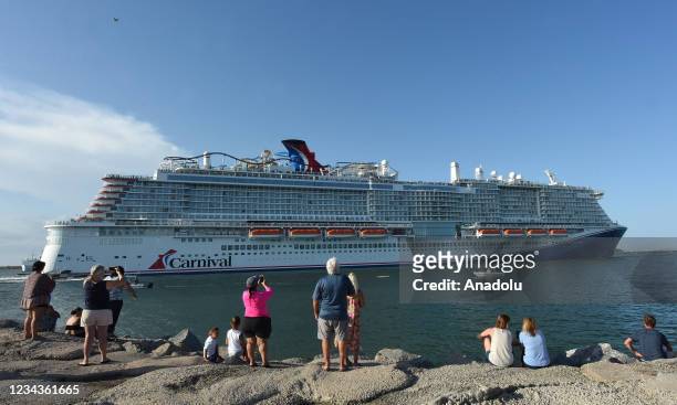 People come out to watch the new Carnival Cruise Line ship Mardi Gras as it departs on its maiden voyage, a seven-day cruise to the Caribbean from...