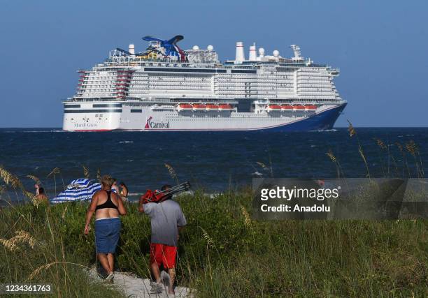 People come out to watch the new Carnival Cruise Line ship Mardi Gras as it departs on its maiden voyage, a seven-day cruise to the Caribbean from...