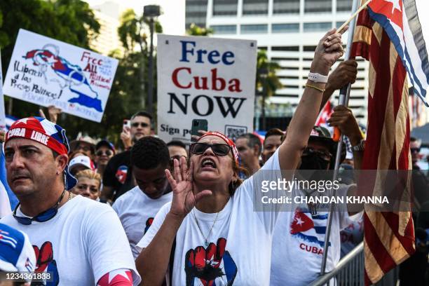 Protestor shouts slogans as people hold "Free Cuba" signs during a rally in calling for Freedom in Cuba, Venezuela and Nicaragua, in Miami, on July...