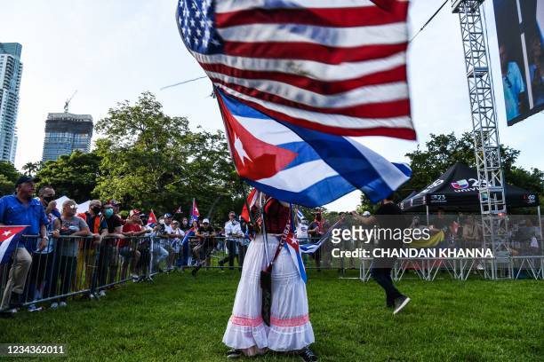 Woman waves Cuban and American flags during a rally in calling for Freedom in Cuba, Venezuela and Nicaragua, in Miami, on July 31, 2021. - Human...