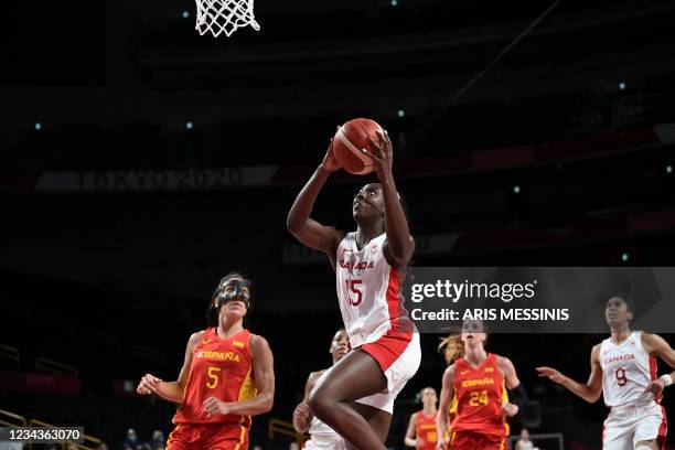 Canada's Laeticia Amihere goes to the basket past Spain's Cristina Ouvina in the women's preliminary round group A basketball match between Spain and...