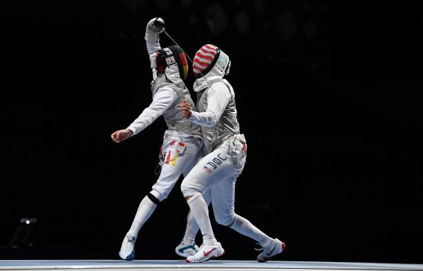 Germany's Andre Sanita compete against USA's Gerek Meinhardt in the mens team foil quarter-final bout during the Tokyo 2020 Olympic Games at the...