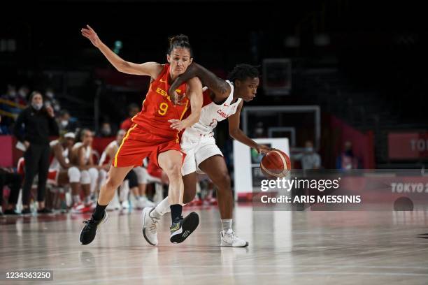 Canada's Shaina Pellington dribbles the ball past Spain's Laia Palau in the women's preliminary round group A basketball match between Spain and...