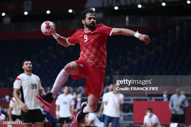 Bahrain's left wing Hasan Al Samahiji jumps to shoot during the men's preliminary round group B handball match between Egypt and Bahrain of the Tokyo...