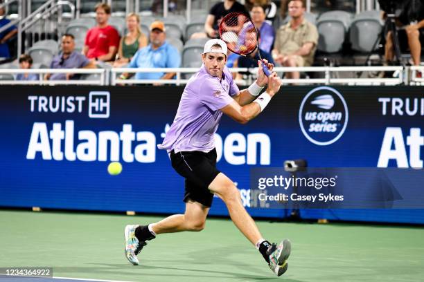 John Isner of the United States looks to return a shot from Taylor Fritz of the United States during a semifinal singles match at the Truist Atlanta...