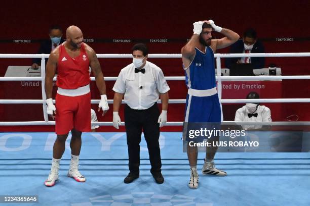 France's Mourad Aliev reacts after losing by disqualification against Britain's Frazer Clarke during their men's super heavy quarter-final boxing...