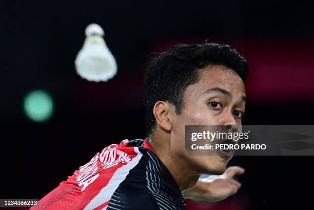 Indonesia's Anthony Sinisuka Ginting hits a shot to China's Chen Long in their men's singles badminton semi-final match during the Tokyo 2020 Olympic...