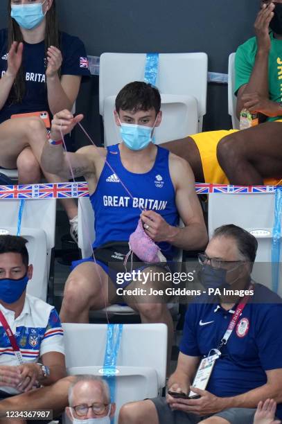 Great Britain's Tom Daley knits in the stands during the Women's 3m Springboard Final at the Tokyo Aquatics Centre on the ninth day of the Tokyo 2020...