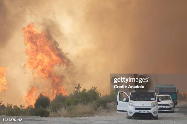 Smoke and flames rise as ground and air support works to extinguish the forest fire that broke out in Manavgat district continue in Antalya, Turkey...