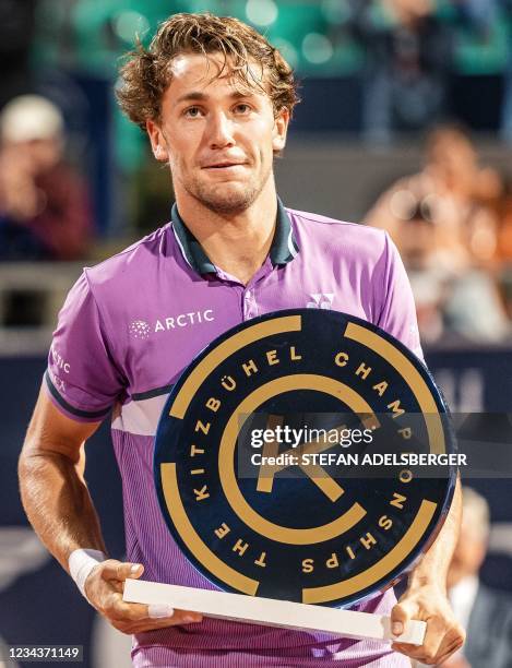 Norway's Casper Ruud poses with the trophy after winning against Spain's Pedro Martinez during the final men's singles match of the Generali Open...