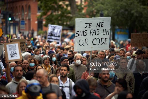 The placard reads 'I'm not a QR code'. Thousands protesters took to the streets in Toulouse against the near mandatory vaccination and against the...
