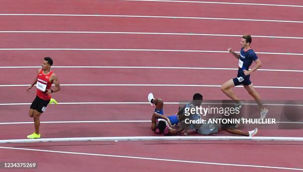 S Isaiah Jewett and Botswana's Nijel Amos react after falling on the track while competing in the men's 800m semi-finals during the Tokyo 2020...