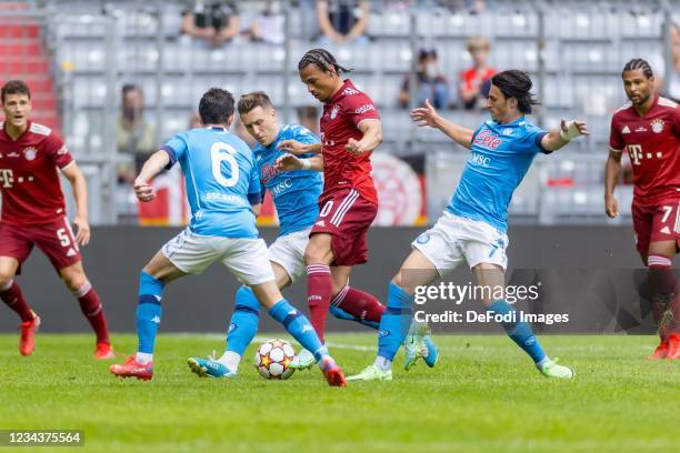 Mario Rui of SSC Neapel, Piotr Zielinski of SSC Neapel, Leroy Sane of Bayern Muenchen and Eljif Elmas of SSC Neapel battle for the ball during the...