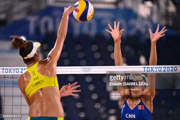Australia's Taliqua Clancy attempts a shot past China's Wang Xinxin in their women's beach volleyball round of 16 match between Australia and China...