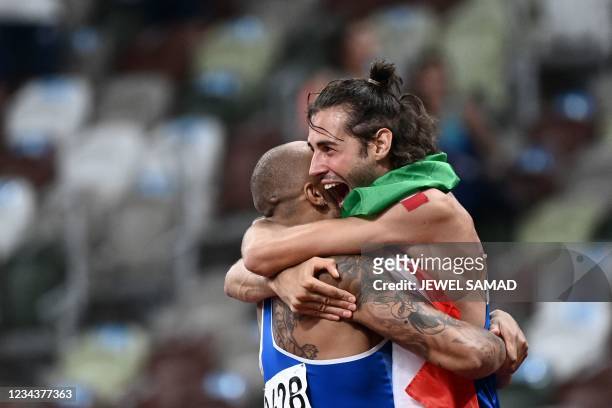 Italy's Lamont Marcell Jacobs celebrates with Italian athlete Gianmarco Tamberi after winning the men's 100m final during the Tokyo 2020 Olympic...
