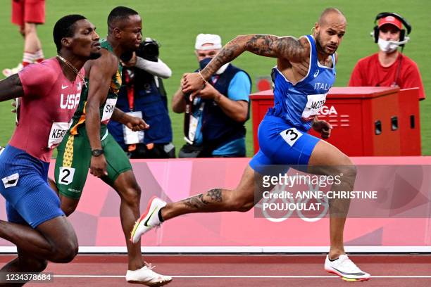 Italy's Lamont Marcell Jacobs, South Africa's Akani Simbine and USA's Fred Kerley compete in the men's 100m final during the Tokyo 2020 Olympic Games...