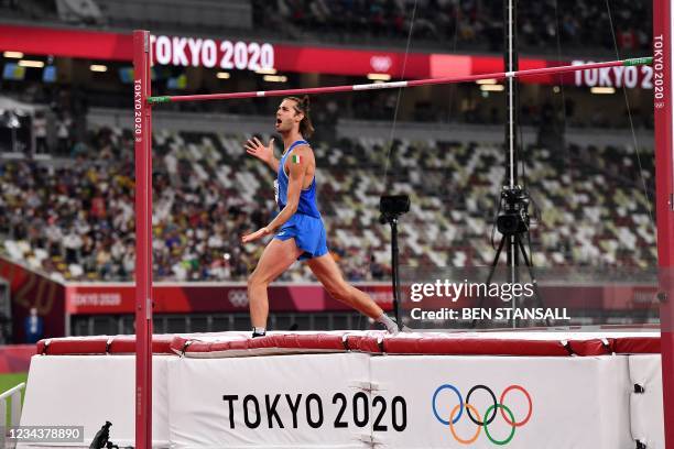 Italy's Gianmarco Tamberi reacts as he competes in the men's high jump final during the Tokyo 2020 Olympic Games at the Olympic Stadium in Tokyo on...