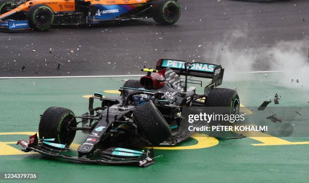 Mercedes' Finnish driver Valtteri Bottas's car is crashed after he collided with Red Bull's Mexican driver Sergio Perez at the start of the Formula...