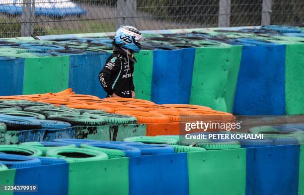 Mercedes' Finnish driver Valtteri Bottas stands next to the race track after crashing during the Formula One Hungarian Grand Prix at the Hungaroring...