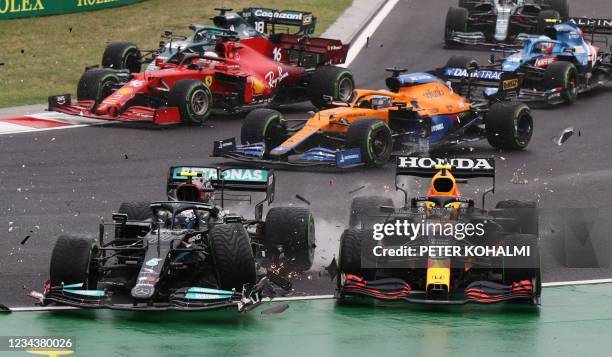 Mercedes' Finnish driver Valtteri Bottas collides with Red Bull's Mexican driver Sergio Perez during the Formula One Hungarian Grand Prix at the...