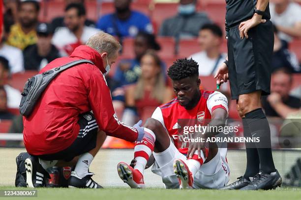 Arsenal's Ghanaian midfielder Thomas Partey receives treatment for an injury during the pre-season friendly football match between Arsenal and...