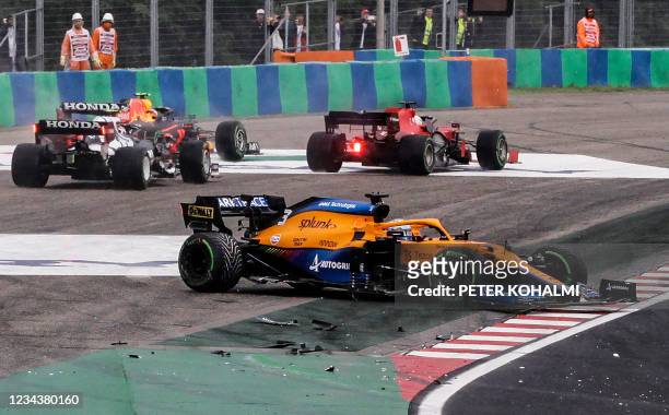 McLaren's Australian driver Daniel Ricciardo stands on the side of the track after his car was involved in a crash at the start of the Formula One...