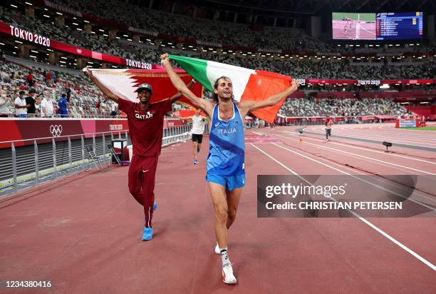 Gold medalists Mutaz Essa Barshim of Team Qatar and Gianmarco Tamberi of Team Italy celebrate on the track following the Men's High Jump Final during...