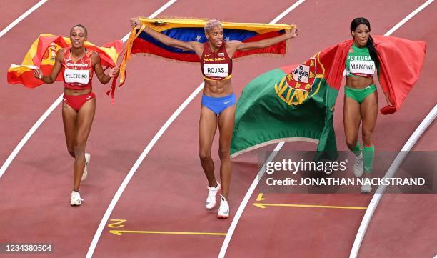 Third-placed Spain's Ana Peleteiro, first-placed Venezuela's Yulimar Rojas and second-placed Portugal's Patricia Mamona celebrates after competing in...