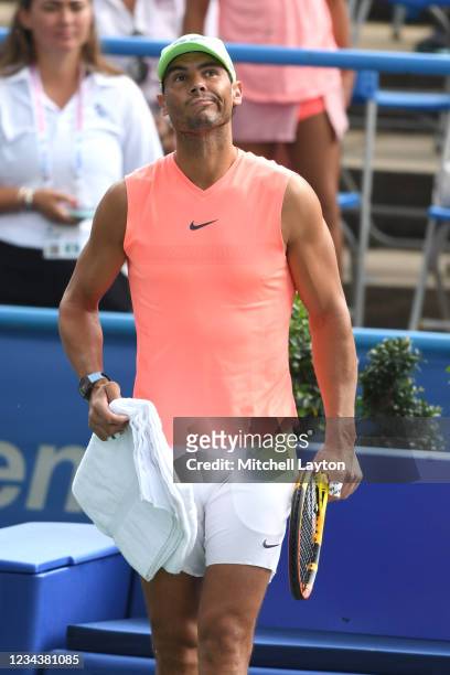 Rafael Nadal of Spain looks on as rain starts during a practice session on Day 2 during the Citi Open at Rock Creek Tennis Center on August 1, 2021...