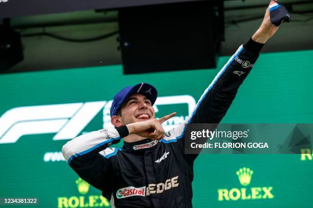 Alpine's French driver Esteban Ocon celebrates on the podium after the Formula One Hungarian Grand Prix at the Hungaroring race track in Mogyorod...