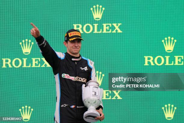 Winner Alpine's French driver Esteban Ocon celebrates on the podium after the Formula One Hungarian Grand Prix at the Hungaroring race track in...