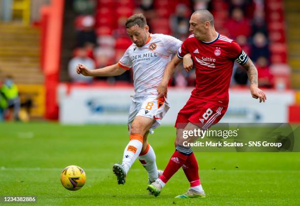 Dundee United's Peter Pawlett in action against Scott Brown during the cinch Premiership match between Aberdeen and Dundee United at Pittodrie...