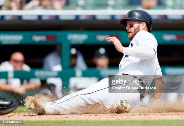 Robbie Grossman of the Detroit Tigers scores from third base on a foul fly out to right fielder Anthony Santander of the Baltimore Orioles during the...