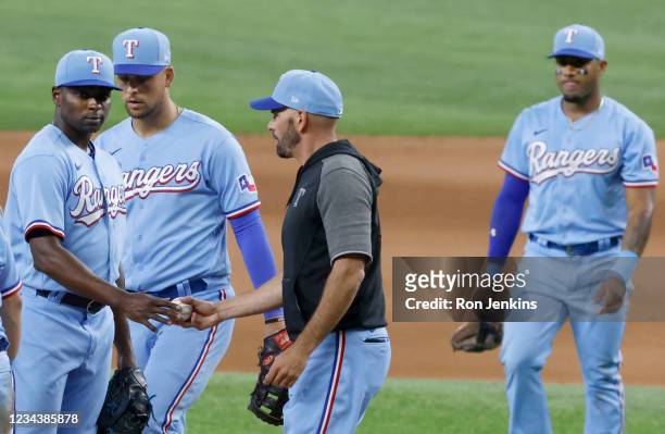 Jharel Cotton of the Texas Rangers is relieved by manager Chris Woodward as the Rangers play the Seattle Mariners during the seventh inning at Globe...