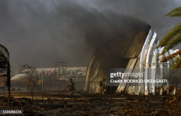 Firefighters try to extinguish a fire at an hangar of the Administration of Airports and Auxiliary Services for Air Navigation , following a fire in...