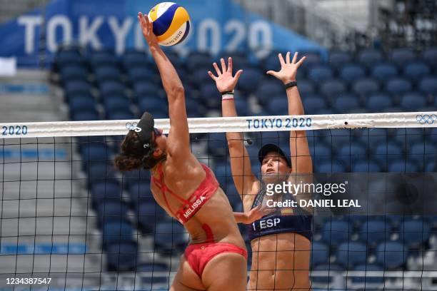 Canada's Melissa Humana-Paredes spikes the ball as Spain's Liliana Fernandez Steiner blocks in their women's beach volleyball round of 16 match...