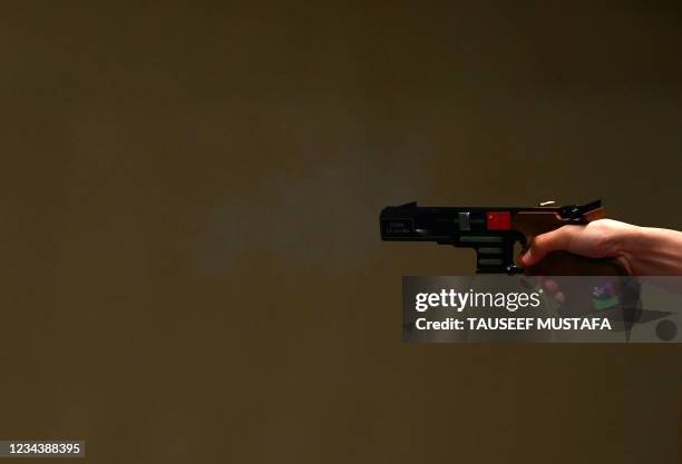 China's Li China's Lin Junmin competes dirung the men's 25m rapid fire pistol qualification during the Tokyo 2020 Olympic Games at the Asaka Shooting...