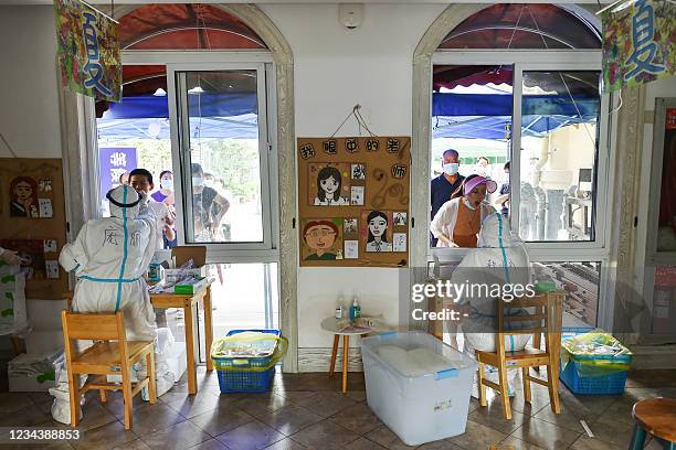 Residents receive nucleic acid tests for the Covid-19 coronavirus in Nanjing in China's eastern Jiangsu province on August 2 amid the country's most...