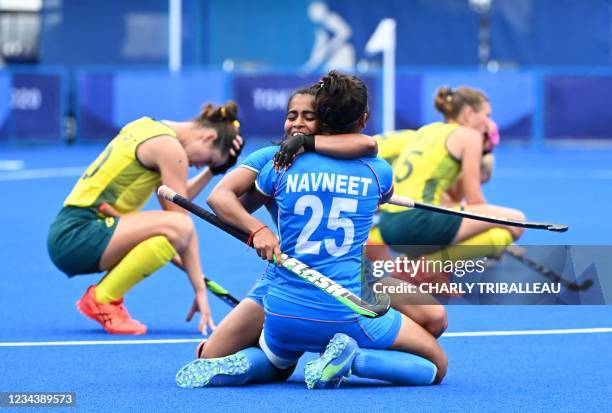 India's Neha and Navneet Kaur celebrate after defeating Australia 1-0 in their women's quarter-final match of the Tokyo 2020 Olympic Games field...