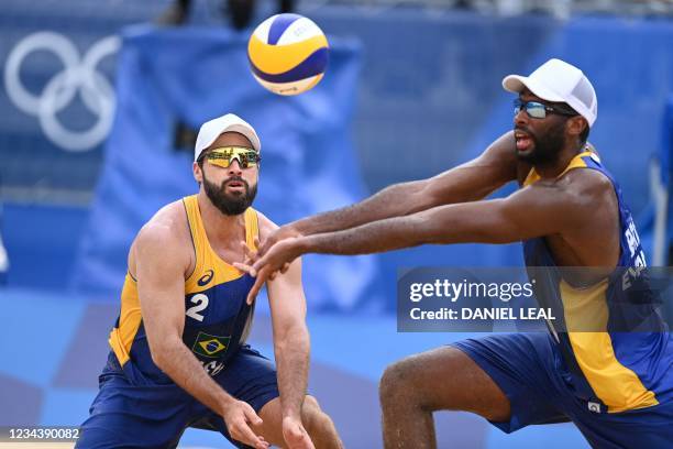 Brazil's Evandro Goncalves Oliveira Junior digs the ball beside partner Bruno Oscar Schmidt in their men's beach volleyball round of 16 match between...