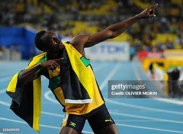 Jamaica's Usain Bolt strikes his trademark pose as he celebrates winning gold in the men's 200 metres final at the International Association of...